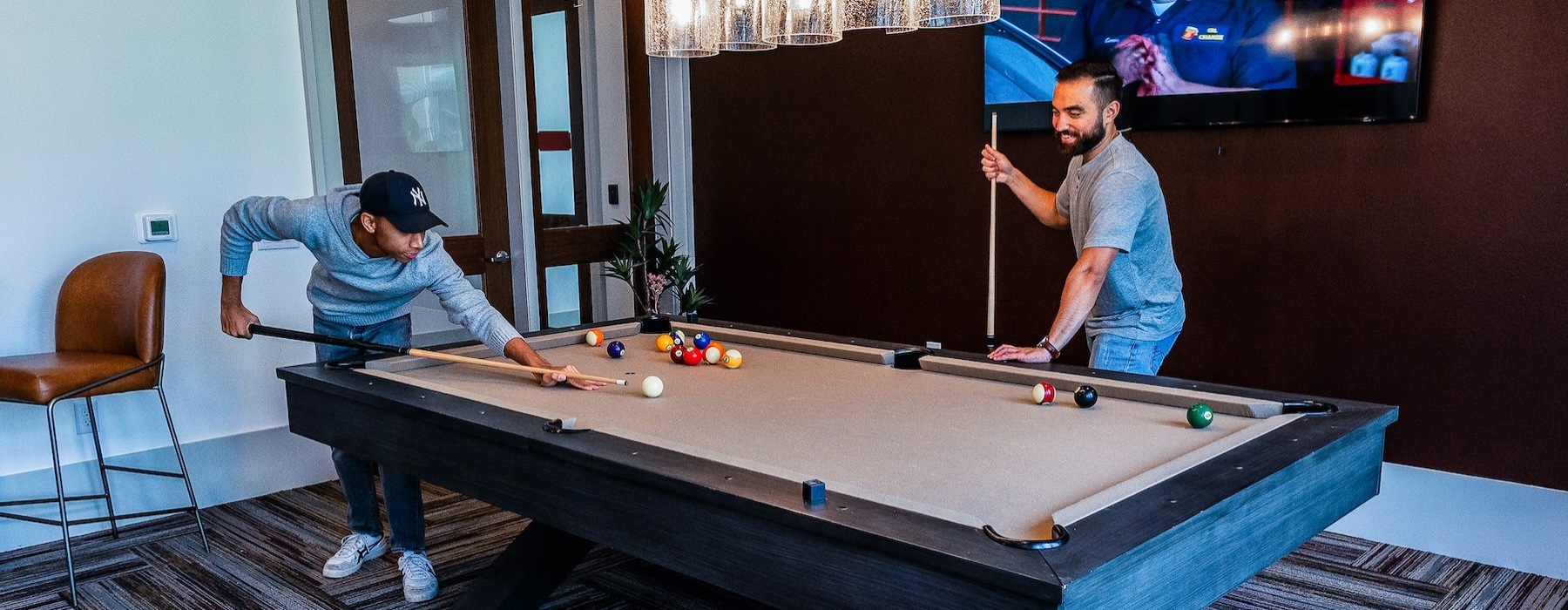 two men playing pool in a clubroom